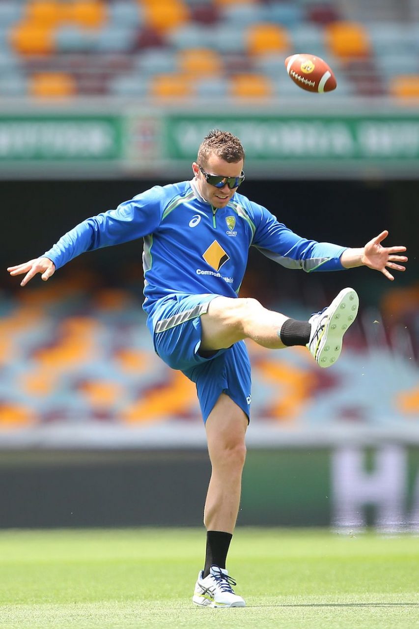 Peter Siddle Kicks A Football At A Practice Session ,