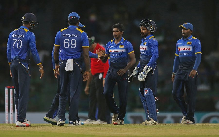 Lakshan Sandakan Celebrates With Team Mates After Dismissing A Wicket